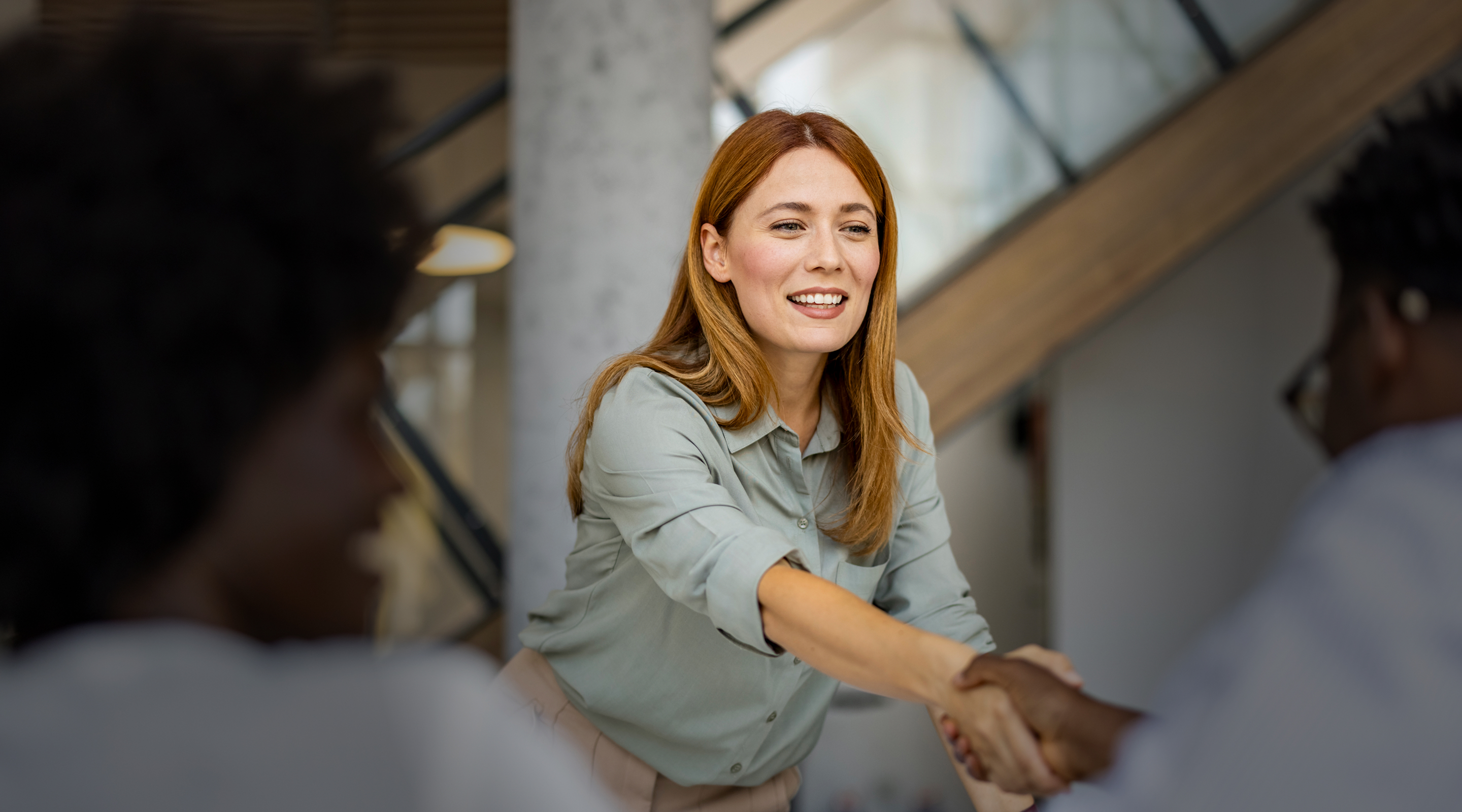 Female attorney shaking clients hand