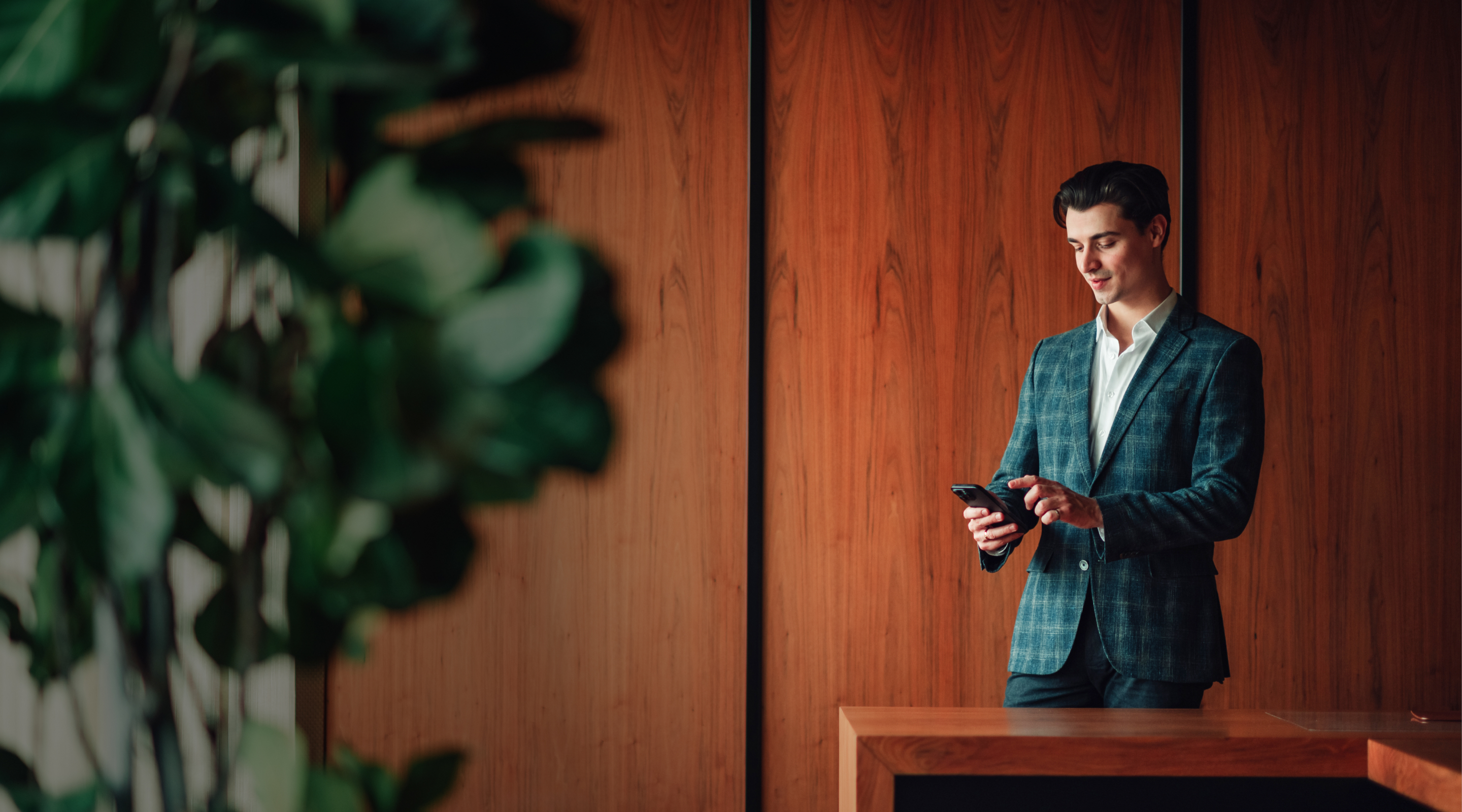 Junior associate lawyer checking phone at desk