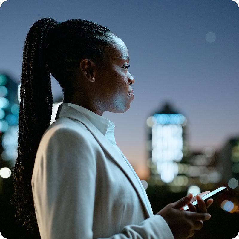 Woman in a city making a call late at night