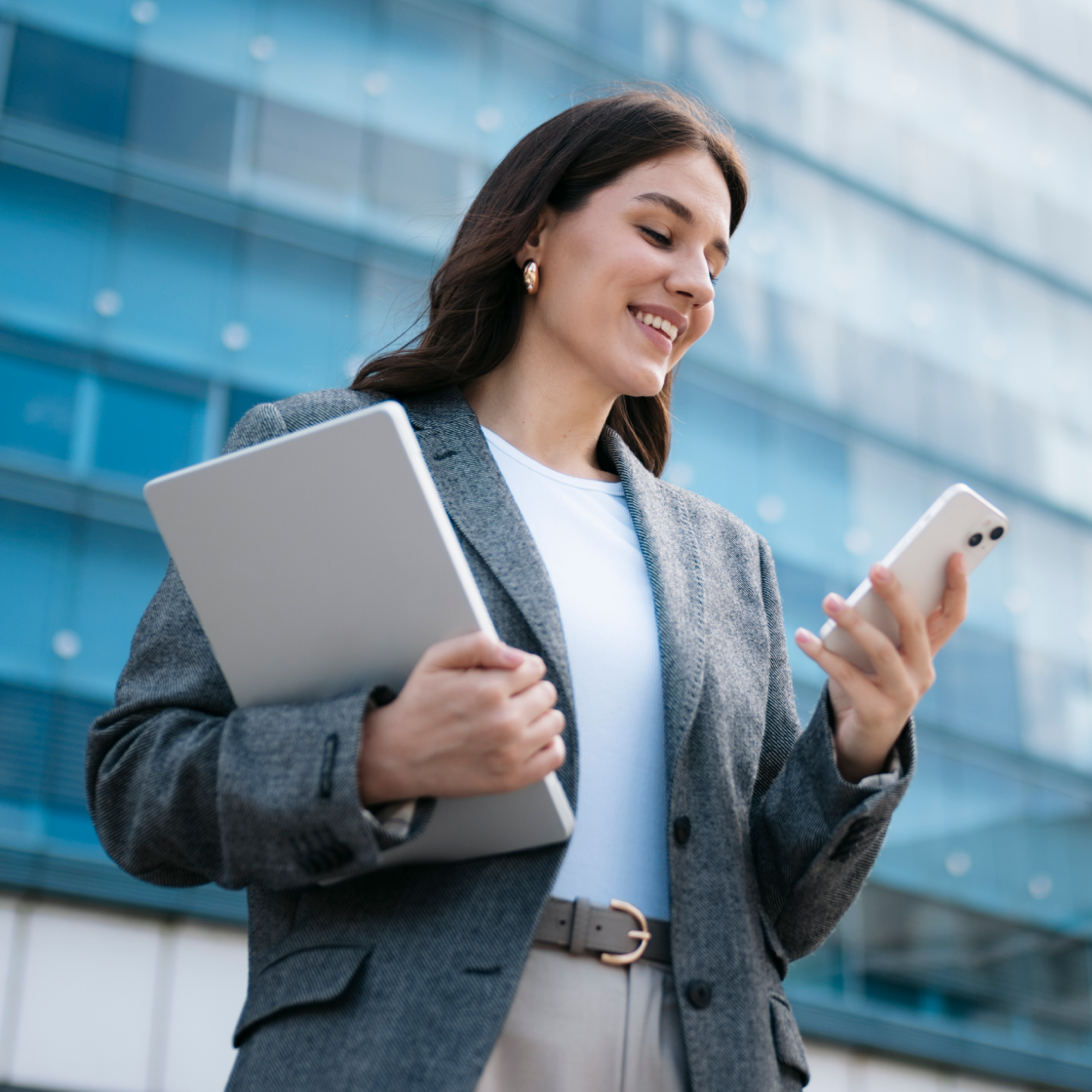 female-trial-attorney-exiting-courthouse-with-smartphone