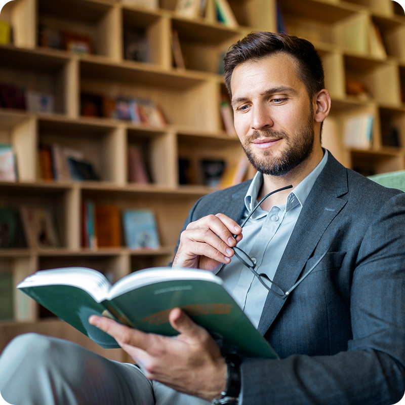 Man reading book in library