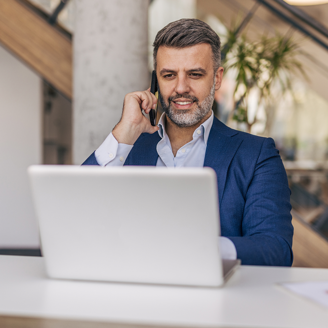 Confident lawyer viewing laptop in a modern office