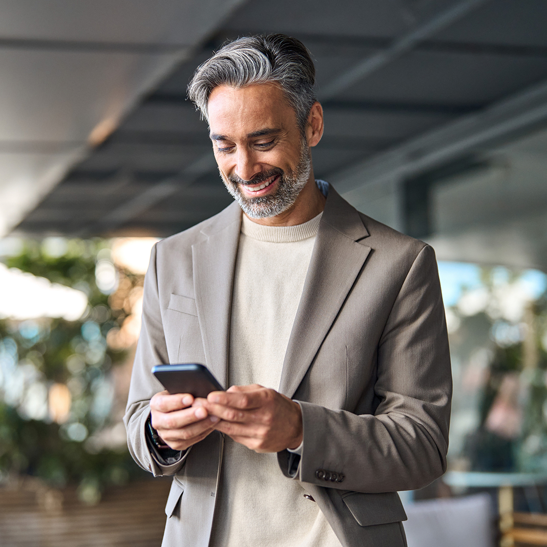 Lawyer happily checking phone at a cafe
