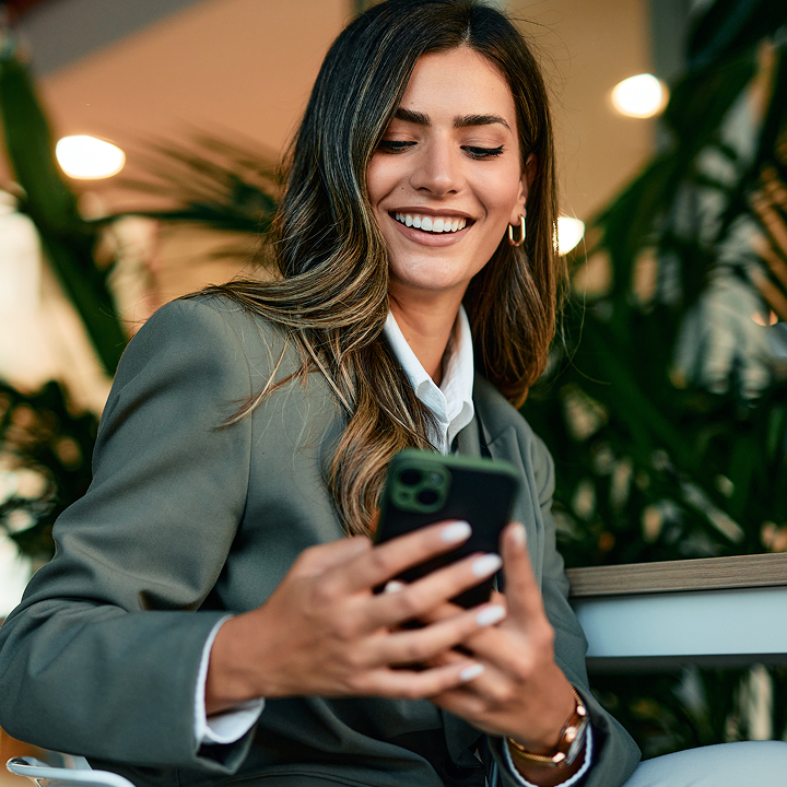 Relaxed attorney checking her phone in cafe