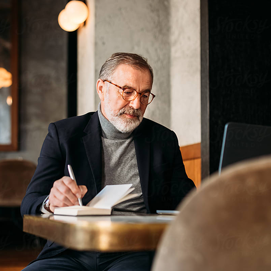 Senior lawyer writing notes from case files