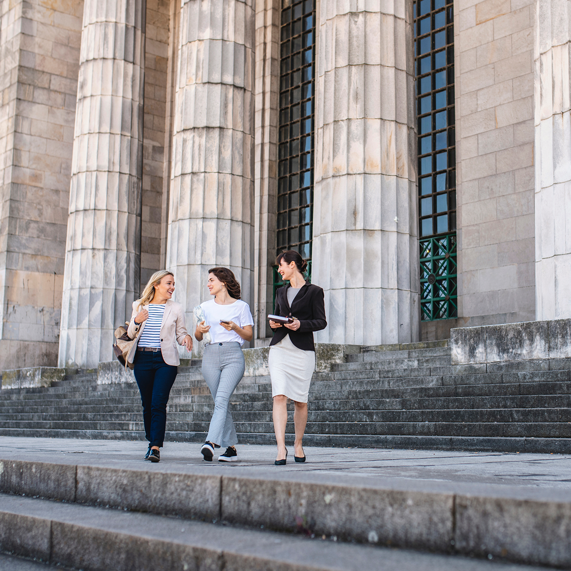 Three women talking outside of courthouse