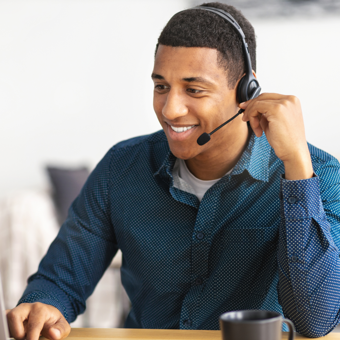 smiling-male-desk-attendant-managing-incoming-phone-lines