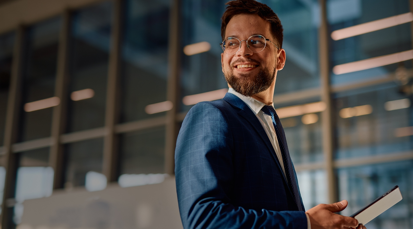 Optimistic lawyer holding a tablet looking back